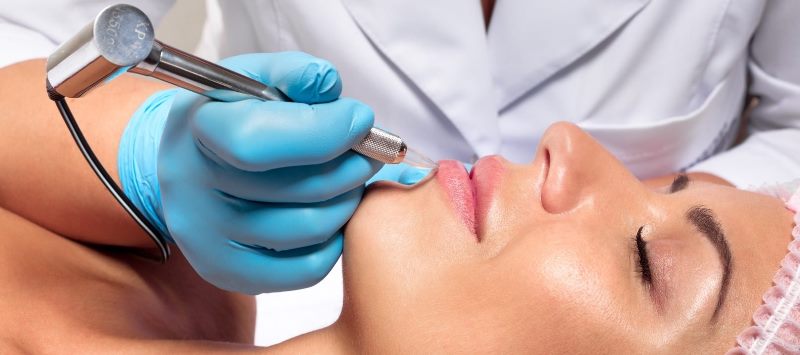 Проводится процедура перманентного макияжа губ 
